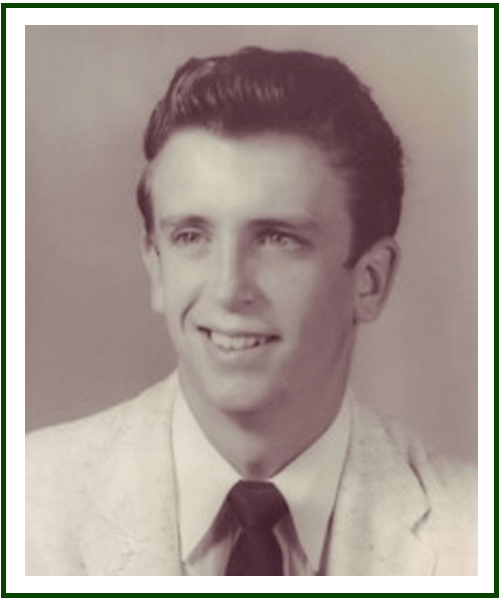 a man wearing a suit and tie smiling at the camera