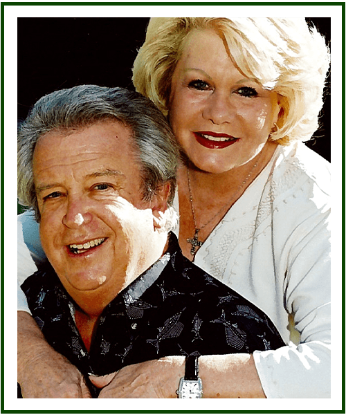 a man and a woman smiling for the camera